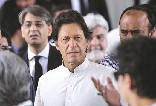 Pakistani opposition leader and head of the Pakistan Tehreek-i-Insaf (PTI) party Imran Khan leaves the Supreme Court after attending a hearing on the Panama Papers case in Islamabad yesterday.