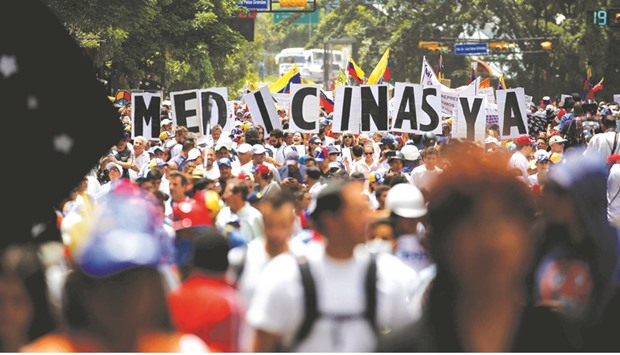 Healthcare workers and opposition activists stage a rally against President Nicolas Maduro in Caracas yesterday.