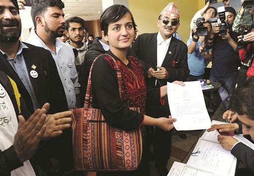 Ranju Darshana, centre, files her nomination for local elections in Kathmandu yesterday.