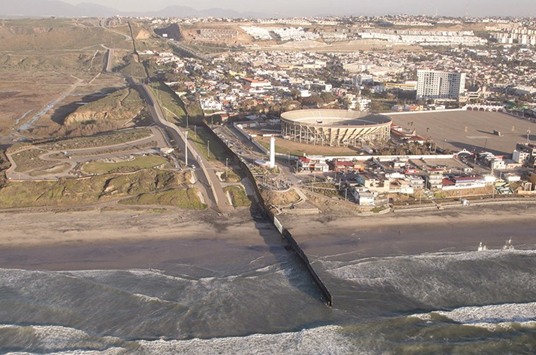 BORDERING INTO THE WATER: An aerial photo flight from Andrade, California on the east end of the US-Mexico border in California to the Pacific Ocean, where the border fence ends in the water. This is where the fence ends, at the Pacific Ocean in the Las Playas section of Tijuana, which is the northwestern most point in Mexico.
