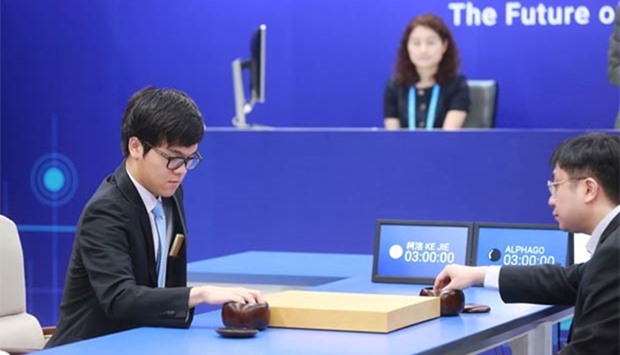 China's 19-year-old Go player Ke Jie (left) prepares to make a move during the first match against Google's artificial intelligence programme AlphaGo in Wuzhen on Tuesday.