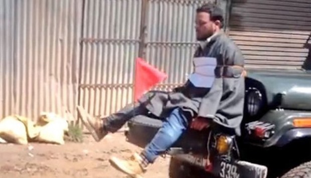 Videograb showing Farooq Ahmad Dar bound to the front of an army jeep