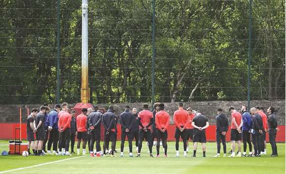  Manchester United players and officials observe a minuteu2019s silence for the victims of the terror attack at Manchester Arena during a team training session near Carrington, west of Manchester, yesterday. (AFP)