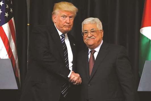 US President Donald Trump and Palestinian President Mahmoud Abbas shake hands as they conclude their remarks after their meeting at the Presidential Palace in the West Bank city of Bethlehem yesterday.
