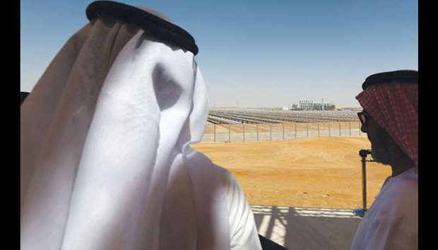 Emarati men stand on a balcony overlooking the Shams 1, Concentrated Solar power (CSP) plant, in Al-Gharibiyah district on the outskirts of Abu Dhabi (file). The UAE and Saudi Arabia, in particular, have embraced the idea of green sukuk after they set ambitious clean energy and energy efficiency targets for their economies.