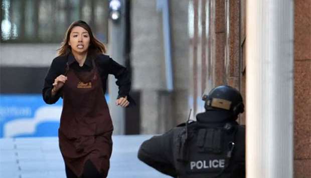 One of the hostages running towards the police from the Lindt cafe in Sydney during a siege in December 2014.