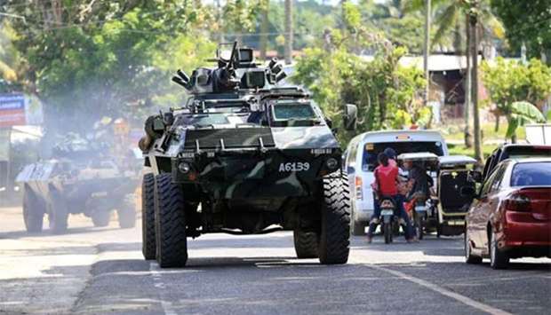 An armoured personnel carrier drives along a main highway of Pantar town, Lanao Del Norte, as it travels to reinforce Marawi city, southern Philippines on Wednesday.