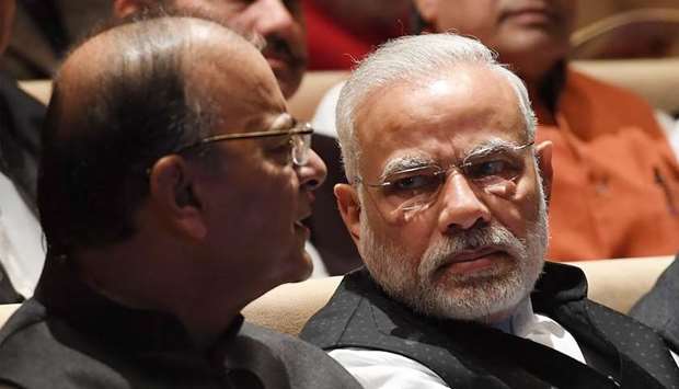India Prime Minister Narendra Modi (R) speaks with Finance Minister Arun Jaitley (L)