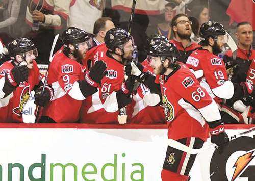 Ottawa Senators forward Mike Hoffman (foreground) celebrates with teammates after scoring the winning goal against Pittsburgh Penguins in Ottawa, Ontario, on Tuesday. (USA TODAY Sports)