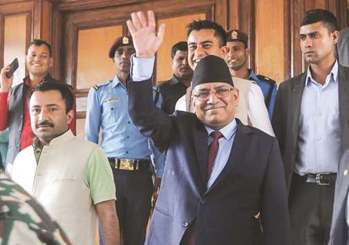 Pushpa Kamal Dahal gestures as he leaves after announcing his resignation during an address to the nation in Kathmandu yesterday.