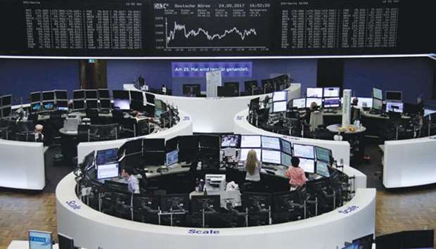 Traders work at the Frankfurt Stock Exchange. The DAX slid 0.1% to 12,642.87 yesterday.