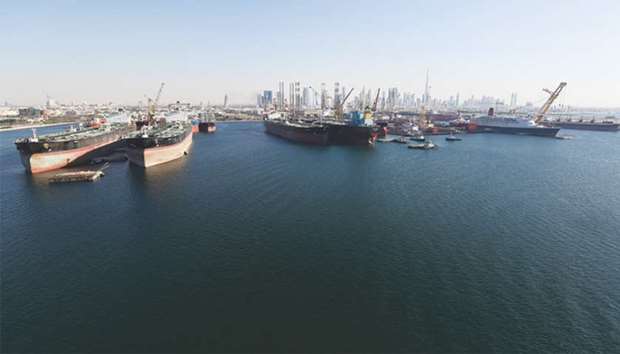 Skyscrapers sit on the horizon beyond oil tankers in the commercial harbour at Port Rashid in Dubai (file). Like other maritime hubs, the UAE and its main shipping centre Dubai are struggling with a near decade long downturn in global shipping, which has hurt profitability.