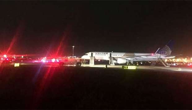 A United Airlines aircraft sits on the tarmac at Newark Liberty International Airport after flames were reported coming from an engine.