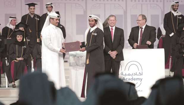 A graduate receives his certificate.