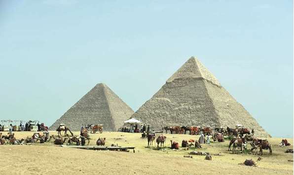 Egyptian camel owners wait for tourists outside the pyramids, on the Giza Plateau, on the southern outskirts of the capital Cairo. Six years after the uprising that ousted president Hosni Mubarak, officials are struggling to rebuild an economy where inflation tops 30% and key industries such as tourism and manufacturing have been hit by terrorism and a lack of foreign investment.