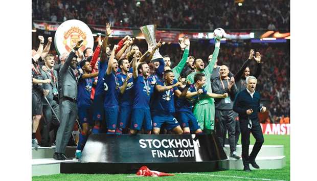 Manchester Unitedu2019s players celebrate with the trophy after winning the UEFA Europa League final against Ajax at the Friends Arena in Solna outside Stockholm.
