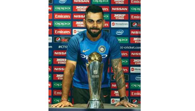 Indiau2019s captain, Virat Kohli poses with the ICC Champions Trophy 2017 at a press conference in London yesterday. (AFP)