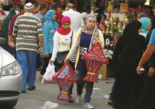 Egyptian women carry traditional u2018fanousu2019 Ramadan lanterns ahead of the holy fasting month of Ramadan in Cairo yesterday.