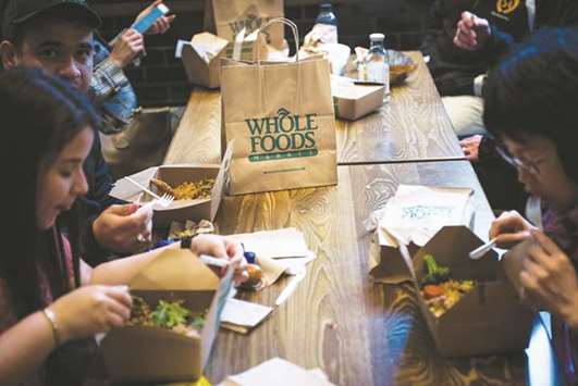 Customers eat inside a Whole Foods Market in New York. In a bid to reignite sales and profit growth by October 2018, Whole Foods said it would expand its nascent loyalty programme and use data to improve how it stocks products.