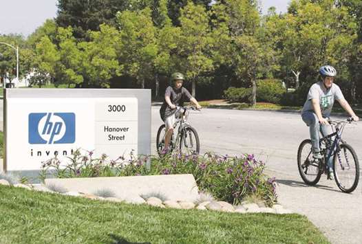 Children ride bikes past a Hewlett Packard sign at HPu2019s Palo Alto headquarters. HPu2019s revenue rose 6.9% to $12.4bn in the period that ended in April, topping analystsu2019 estimates for the fourth consecutive quarter.