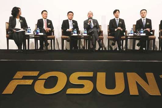 Fosun International chairman Guo Guangchang (4th from left) speaks at a news conference in Hong Kong. Australiau2019s top energy retailer Origin has drawn interest from at least five potential bidders, including Chinau2019s Fosun, for A$2bn ($1.5bn) worth of oil and gas assets it aims to spin off, sources said yesterday.