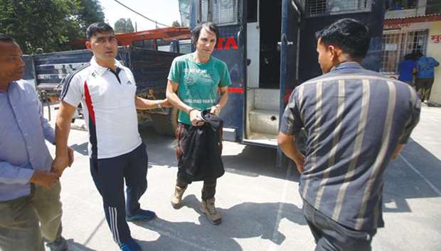This file photo shows Ryan Sean Davy being escorted by Nepalese police ahead of his bail hearing at the district office in Kathmandu.