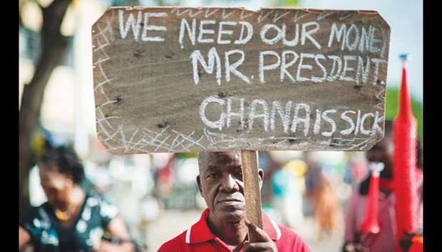 A man holds up a placard reading u2018We need our money Mr President - Ghana is sicku2019 during a demonstration dubbed u2018Fabewoso - Bring it onu2019 to raise awareness about the high rate of corruption in the country, as they march in Accra.