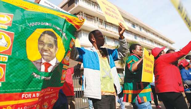 Supporters of Zambian opposition leader Hakainde Hichilema demonstrate alongside supporters of main opposition party Democratic Alliance (DA) outside the High Commission of Zambia in Pretoria, South Africa.