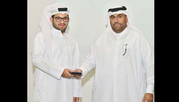 A student receiving a certificate from CAS dean Dr Rashid al-Kuwari.