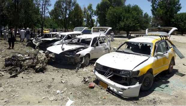 Damaged vehicles are seen after a suicide car bomb attack in Khost province on Saturday.