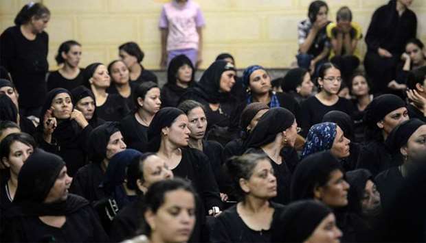Relatives of killed Coptic Christians grieve as they gather during the funeral at Abu Garnous Cathedral