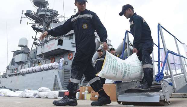 Indian Navy troops offload emergency supplies from the Indian ship Kirch at Colombo harbour yesterday.