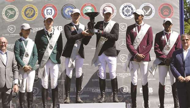 Miami Gloryu2019s Scott Brash and Denis Lynch lift the winnersu2019 trophy, ahead of second-placed Chantilly Pegasus (left) and Doha Fursan Qatar (right) in the Hamburg leg of Global Champions League yesterday. (GCL)