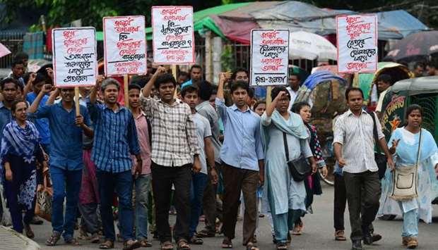 Bangladeshi left wing students march in the street towards the Supreme Court to protest in Dhaka after the removal of a controversial statue