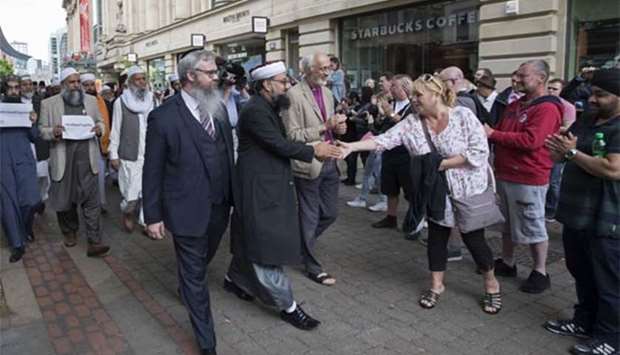 Multi-faith leaders make their way to a gathering in St Ann's square for the victims of the Manchester bombing on Sunday.