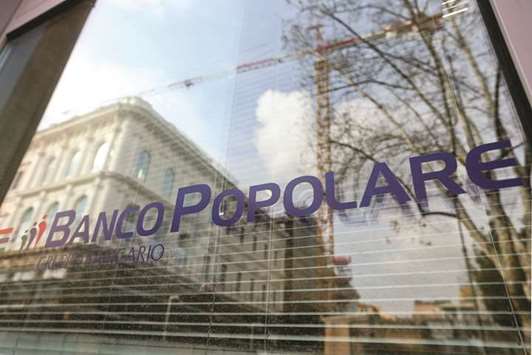 The Banco Popolare logo is seen on a window at one of the companyu2019s bank branches in Rome. Banco Popolare offloaded treasury shares, along with additional Tier 1 notes issued by itself and other lenders, according to people with knowledge of the sales.