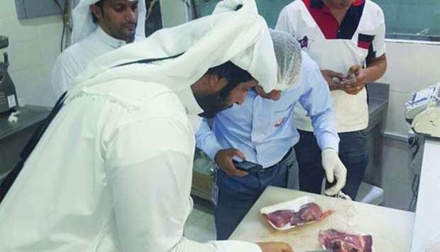Inspectors examine meat during the campaign.