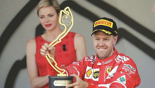 Ferrariu2019s Sebastian Vettel celebrates on the podium after winning the Monaco Grand Prix. (Reuters)