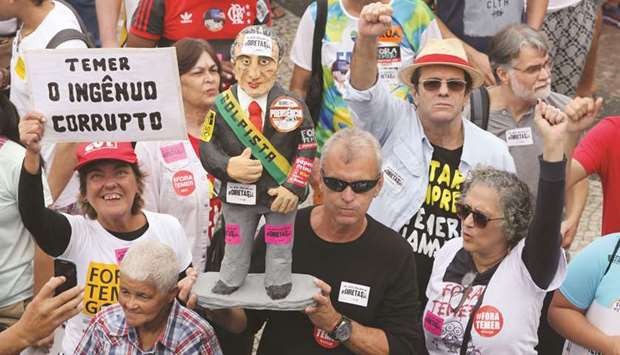 People attend a protest against Brazilu2019s President Michel Temer in Rio de Janeiro, Brazil, yesterday.