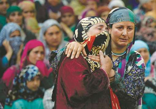 Villagers mourn during the funeral procession of rebel commander Sabzar Ahmad Bhat in Rathsuna Tral, near Srinagar, yesterday.