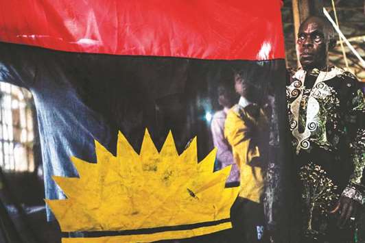 A supporter of the the Indigenous People of Biafra displays the Biafra flag during a service at the St Martin Tour Catholic Church in the Aba-South district of Aba.