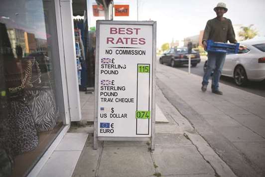 A sign advertising foreign exchange rates for euros, sterling and US dollars outside a store in Limassol, Cyprus. The low-tax island in the eastern Mediterranean is home to 130 retail forex brokers, the most in Europe.