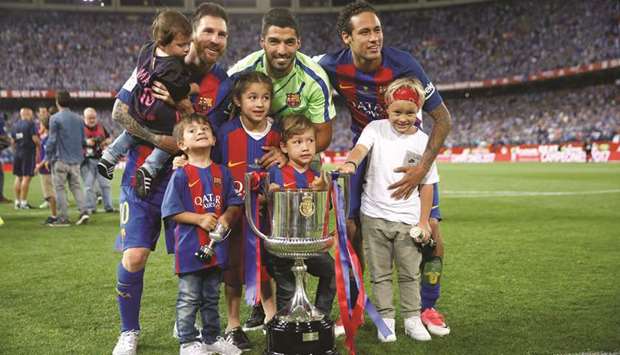 Barcelonau2019s Lionel Messi, Luis Suarez and Neymar celebrate with their children and the Copa del Rey trophy at the end of the match against Deportivo Alaves at the Vicente Calderon Stadium in Madrid on Saturday. (Reuters)