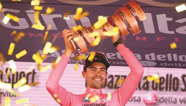Tom Dumoulin of team Sunweb holds the trophy on the podium after winning the Giro 100 yesterday. (AFP)