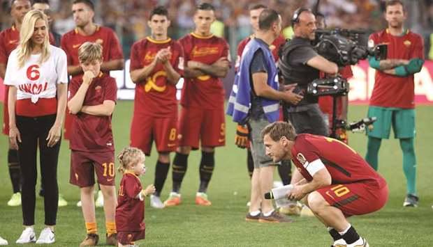 Romau2019s Francesco Totti (right) with his wife Ilary Blasi, daughter Isabel and son Cristian after his last game yesterday. (Reuters)