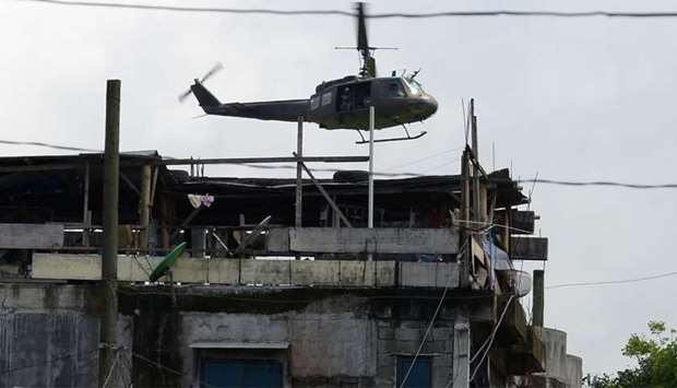 A military helicopter flies past houses in Marawi on the southern island of Mindanao