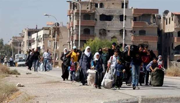 People leaving a  Damascus suburb in this file picture.