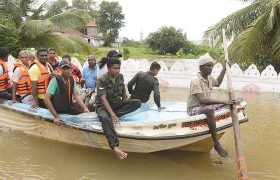 Villagers are evacuated through floodwaters in Nagoda in Kalutara district yesterday.