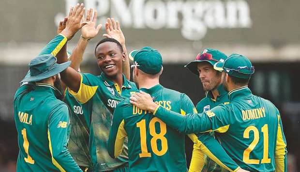 South Africau2019s Kagiso Rabada (second left) celebrates with teammates after taking the wicket of Englandu2019s Adil Rashid during the third ODI at Lordu2019s in London. (AFP)