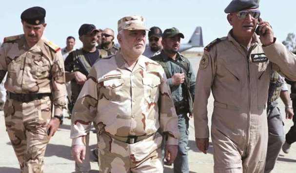 Iraqi Prime Minister Haider al-Abadi (centre) walks during his visit to Mosul, yesterday.